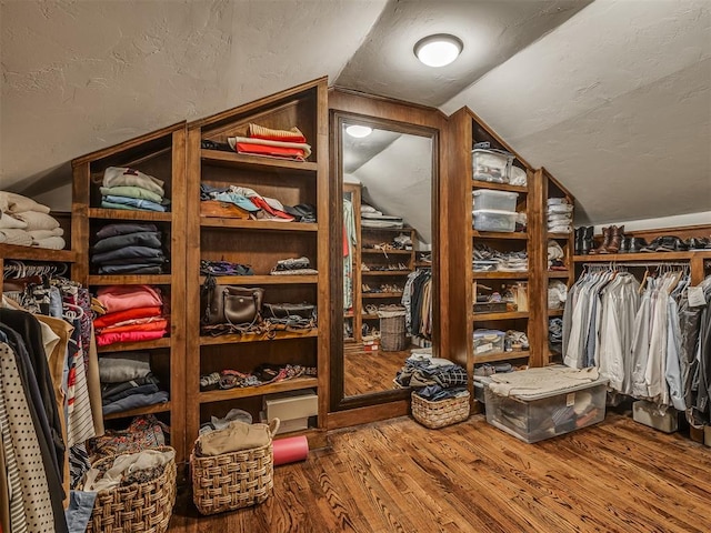 1718 Guilford Ln, Oklahoma City, OK 73120 - walk in closet with wood finished floors and vaulted ceiling