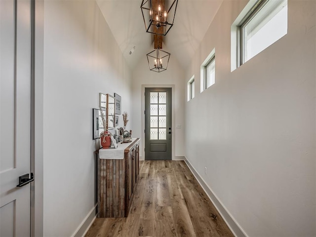 7290 NE Hawk Dr, Piedmont, OK 73078 - entryway with a chandelier, light wood-style floors, and high vaulted ceiling