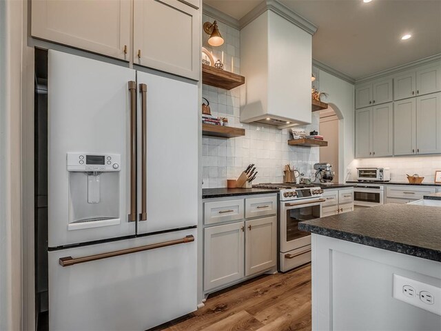 7290 NE Hawk Dr, Piedmont, OK 73078 - kitchen featuring white appliances, open shelves, dark countertops, arched walkways, and recessed lighting