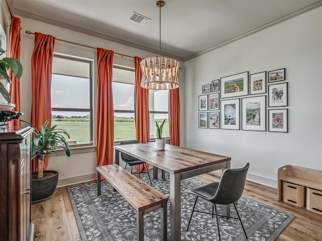 7290 NE Hawk Dr, Piedmont, OK 73078 - dining area featuring plenty of natural light, crown molding, a chandelier, and wood finished floors