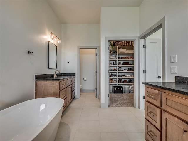 7290 NE Hawk Dr, Piedmont, OK 73078 - full bath featuring vanity, a freestanding tub, and a walk in closet