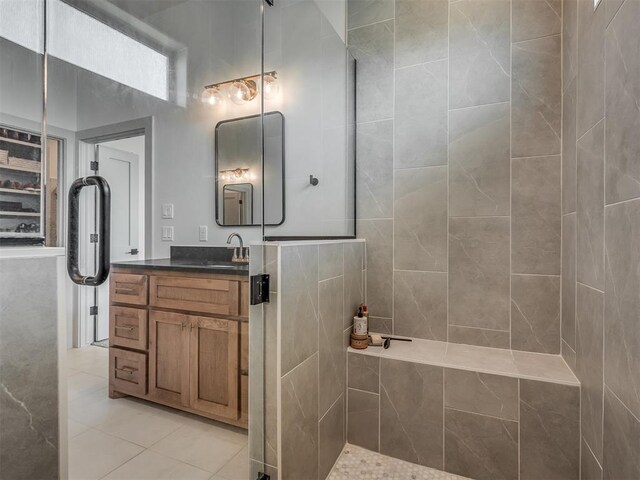 7290 NE Hawk Dr, Piedmont, OK 73078 - full bathroom featuring vanity, tile patterned floors, and tiled shower