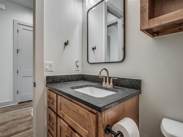 7290 NE Hawk Dr, Piedmont, OK 73078 - half bath featuring vanity and wood finished floors