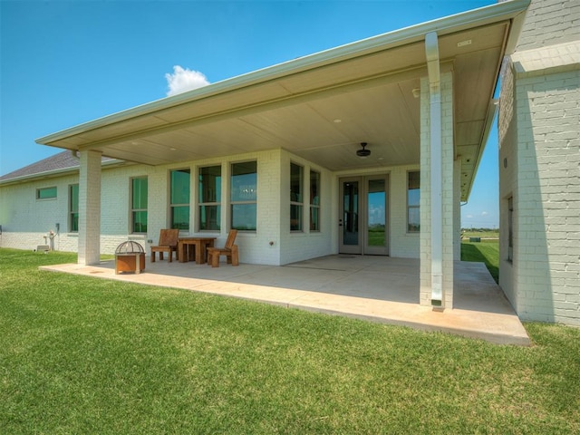 7290 NE Hawk Dr, Piedmont, OK 73078 - rear view of property with brick siding, a patio, and a lawn