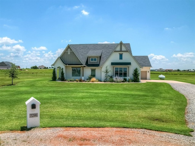 7290 NE Hawk Dr, Piedmont, OK 73078 - view of front of house with driveway, a front lawn, a garage, board and batten siding, and roof with shingles