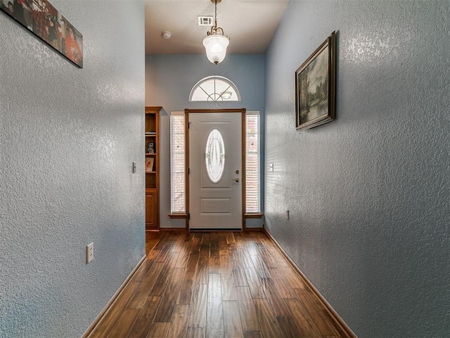 4821 SE 52nd St, Oklahoma City, OK 73135 - doorway featuring a textured wall, healthy amount of natural light, and hardwood / wood-style floors