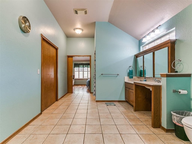 4821 SE 52nd St, Oklahoma City, OK 73135 - bathroom featuring vanity, tile patterned floors, and vaulted ceiling