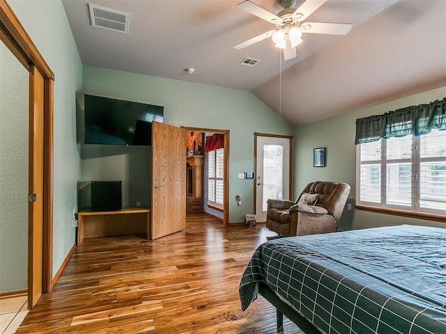 4821 SE 52nd St, Oklahoma City, OK 73135 - bedroom featuring wood finished floors, multiple windows, lofted ceiling, and a closet