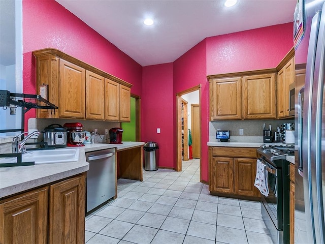 4821 SE 52nd St, Oklahoma City, OK 73135 - kitchen with appliances with stainless steel finishes, light countertops, brown cabinetry, light tile patterned flooring, and recessed lighting