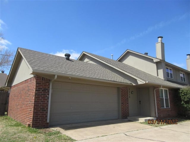 7312 NW 94th St, Oklahoma City, OK 73162 - view of front of house with brick siding, a garage, driveway, a chimney, and a shingled roof