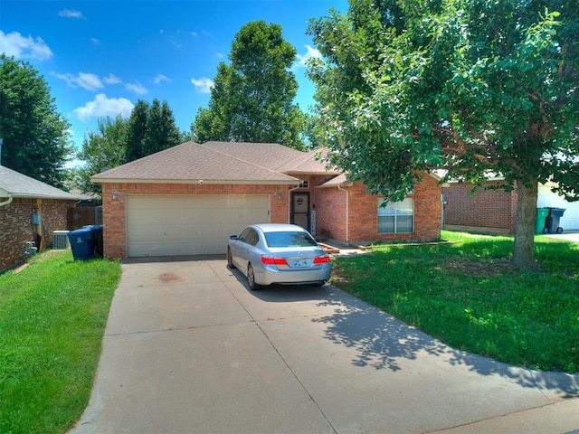 12320 NW 4th St, Yukon, OK 73099 - single story home featuring concrete driveway, an attached garage, brick siding, and a front lawn