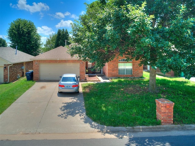 12320 NW 4th St, Yukon, OK 73099 - view of front facade with concrete driveway, a garage, brick siding, and a front yard