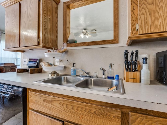 12320 NW 4th St, Yukon, OK 73099 - kitchen with black dishwasher, light countertops, ceiling fan, and brown cabinets
