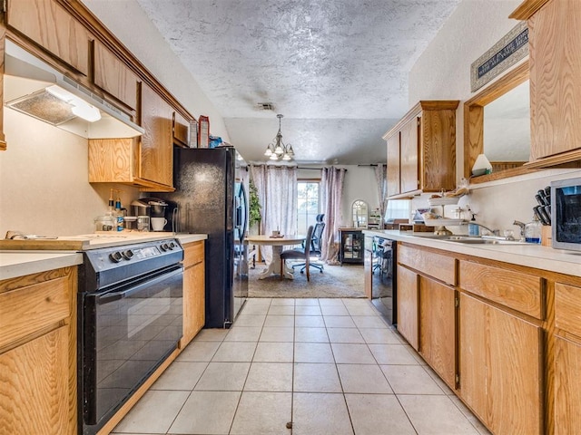 12320 NW 4th St, Yukon, OK 73099 - kitchen featuring black appliances, a chandelier, light countertops, exhaust hood, and light tile patterned floors