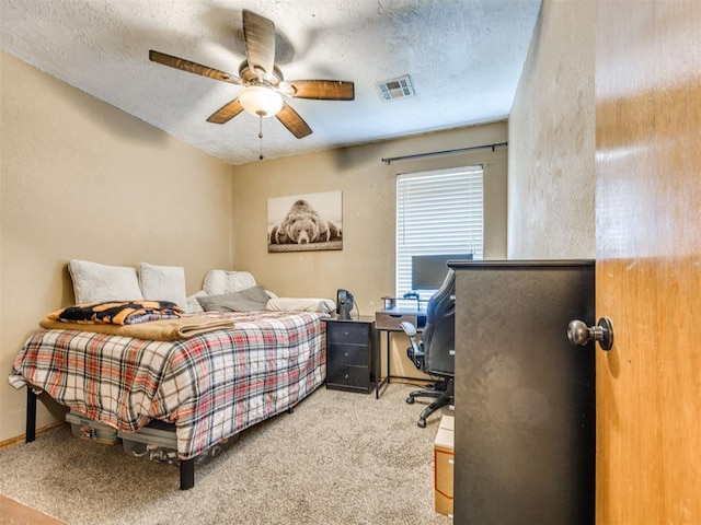 12320 NW 4th St, Yukon, OK 73099 - bedroom with carpet floors, a textured ceiling, a desk, and ceiling fan