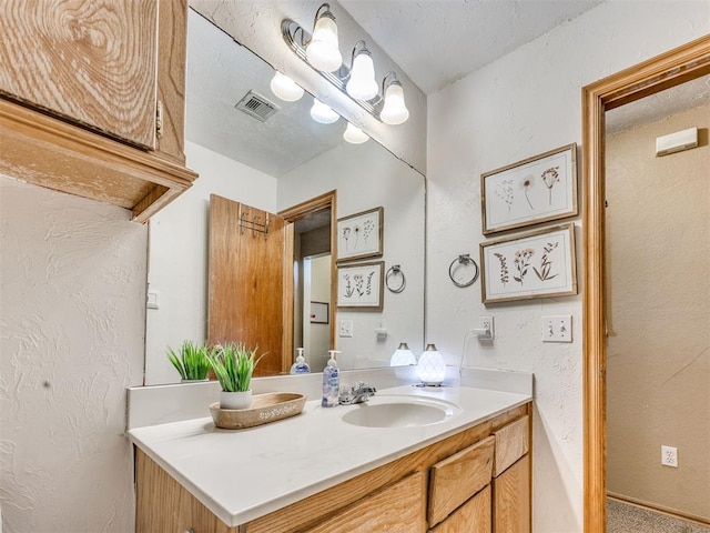 12320 NW 4th St, Yukon, OK 73099 - bathroom featuring vanity, a textured wall, and a textured ceiling
