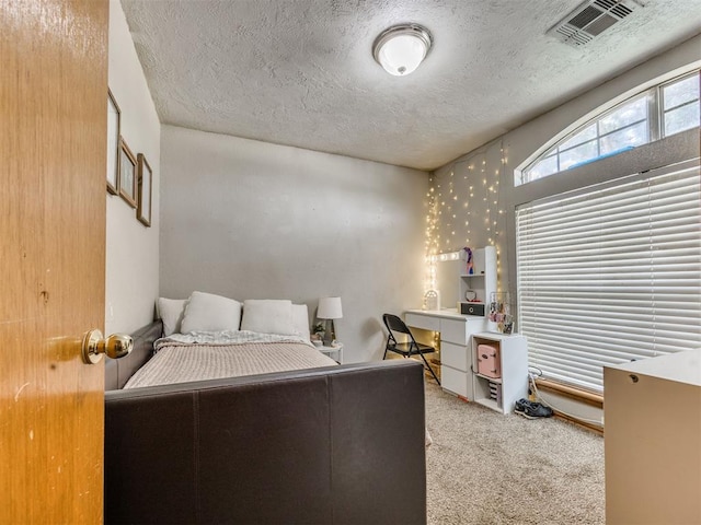12320 NW 4th St, Yukon, OK 73099 - carpeted bedroom featuring a textured ceiling