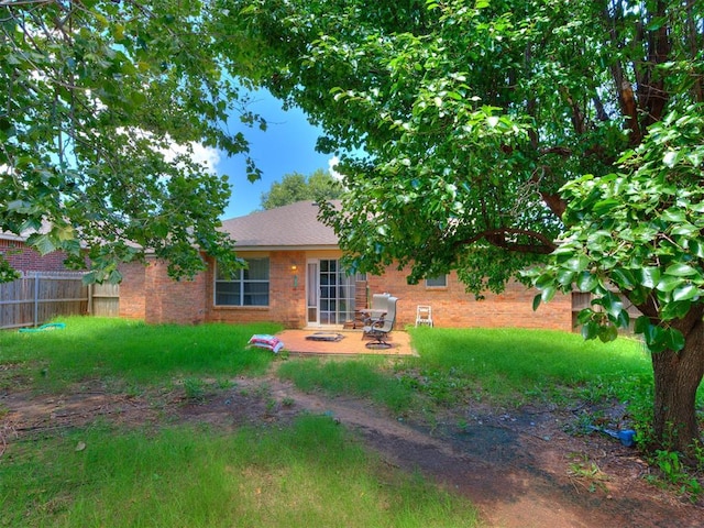 12320 NW 4th St, Yukon, OK 73099 - back of property with a patio and brick siding