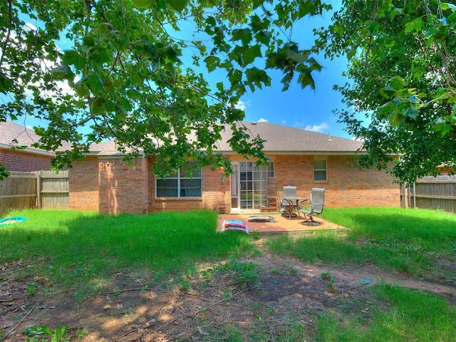 12320 NW 4th St, Yukon, OK 73099 - back of house featuring brick siding and a patio area