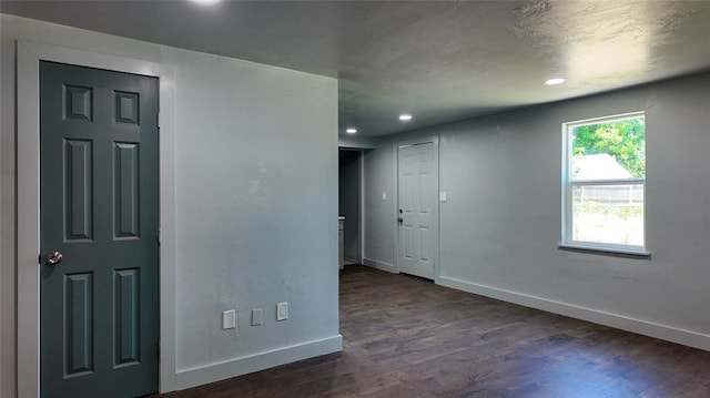 5717 S Francis Ave, Oklahoma City, OK 73109 - unfurnished room featuring dark wood-style flooring and recessed lighting