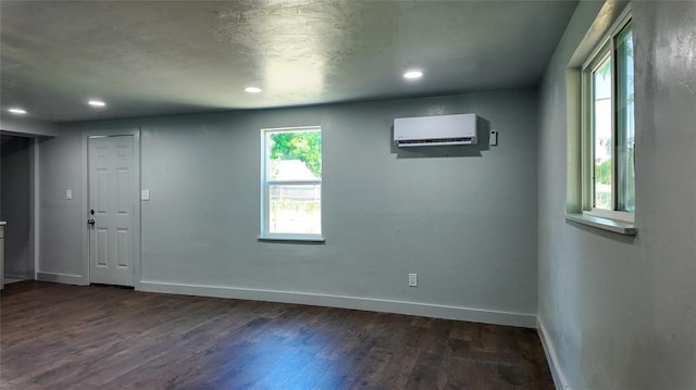5717 S Francis Ave, Oklahoma City, OK 73109 - unfurnished room with dark wood-type flooring, an AC wall unit, and recessed lighting