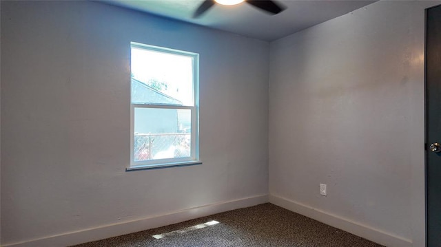 5717 S Francis Ave, Oklahoma City, OK 73109 - unfurnished room with plenty of natural light, ceiling fan, and dark colored carpet