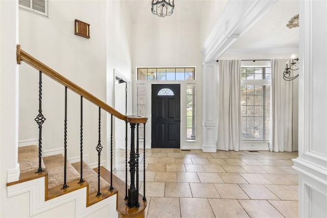1505 S Augusta Dr, Ada, OK 74820 - foyer with stairs, ornamental molding, and decorative columns