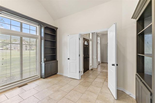 1505 S Augusta Dr, Ada, OK 74820 - spare room with lofted ceiling and light tile patterned flooring