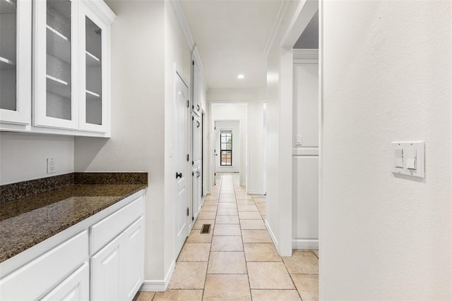 1505 S Augusta Dr, Ada, OK 74820 - hallway with ornamental molding and light tile patterned floors