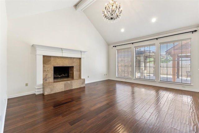 1505 S Augusta Dr, Ada, OK 74820 - unfurnished living room featuring dark wood finished floors, a chandelier, beam ceiling, a tile fireplace, and high vaulted ceiling