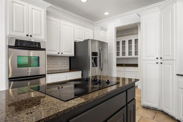 1505 S Augusta Dr, Ada, OK 74820 - kitchen featuring stainless steel appliances, white cabinetry, dark stone counters, crown molding, and backsplash