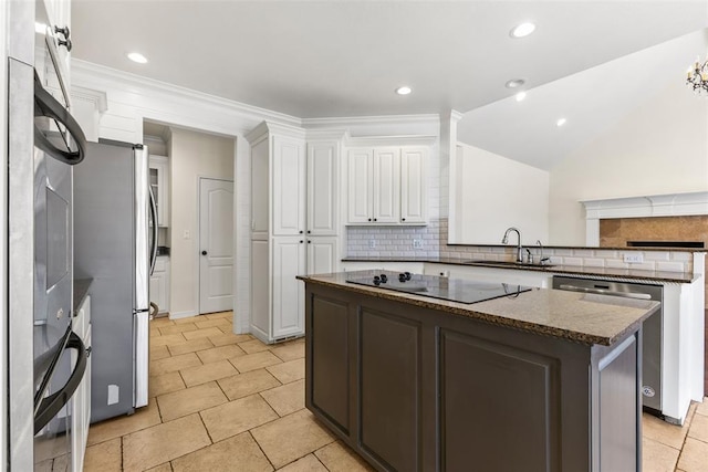 1505 S Augusta Dr, Ada, OK 74820 - kitchen with appliances with stainless steel finishes, a kitchen island, decorative backsplash, white cabinets, and a peninsula