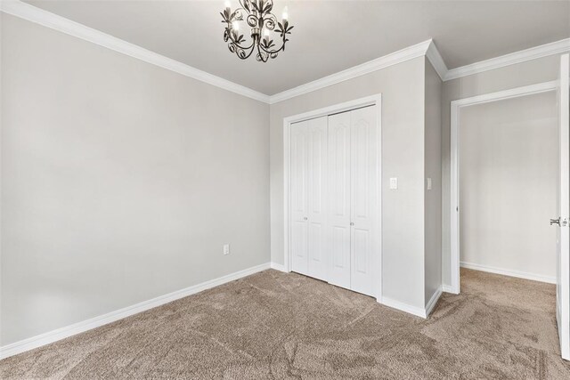 1505 S Augusta Dr, Ada, OK 74820 - unfurnished bedroom with carpet floors, a chandelier, crown molding, and a closet