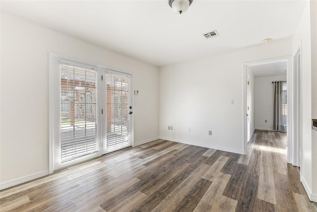 1505 S Augusta Dr, Ada, OK 74820 - spare room featuring wood finished floors and baseboards