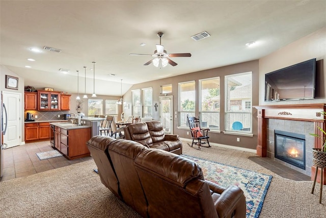 2308 SW 135th St, Oklahoma City, OK 73170 - living area with a tile fireplace, ceiling fan, light carpet, and recessed lighting