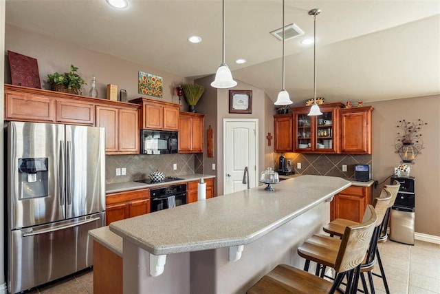 2308 SW 135th St, Oklahoma City, OK 73170 - kitchen with black appliances, brown cabinetry, light tile patterned flooring, tasteful backsplash, and recessed lighting