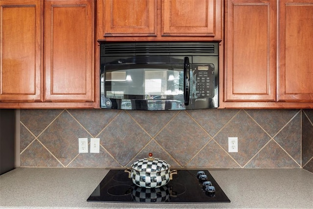 2308 SW 135th St, Oklahoma City, OK 73170 - kitchen featuring black appliances, decorative backsplash, brown cabinetry, and light countertops