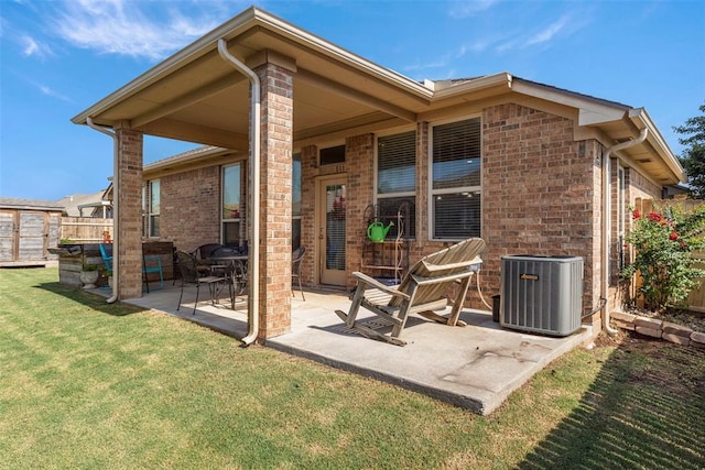 2308 SW 135th St, Oklahoma City, OK 73170 - back of property featuring a patio, brick siding, and an outbuilding
