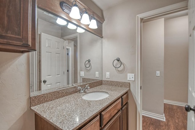 9544 SW 27th St, Oklahoma City, OK 73128 - bathroom featuring vanity and wood finished floors