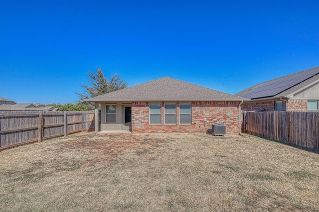 9544 SW 27th St, Oklahoma City, OK 73128 - rear view of house featuring a fenced backyard, brick siding, and roof with shingles