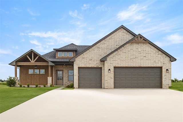 29744 Jade St, Cashion, OK 73016 - view of front of house featuring a garage, driveway, a front lawn, brick siding, and a shingled roof