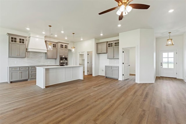 29744 Jade St, Cashion, OK 73016 - kitchen featuring gray cabinets, custom range hood, a ceiling fan, tasteful backsplash, and recessed lighting