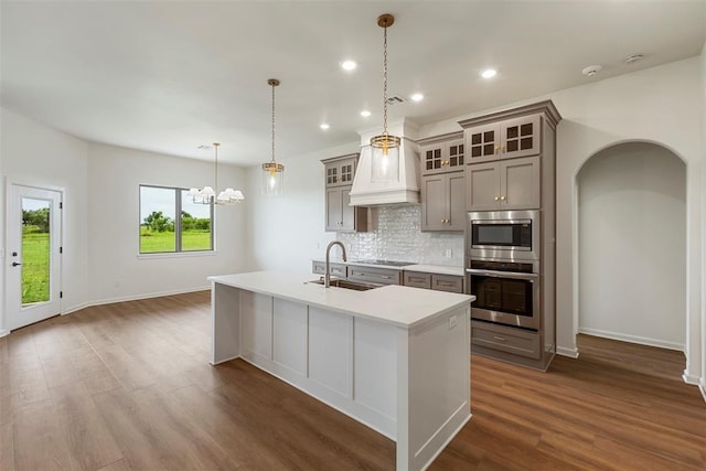 29744 Jade St, Cashion, OK 73016 - kitchen with stainless steel appliances, gray cabinets, backsplash, a kitchen island with sink, and dark wood finished floors