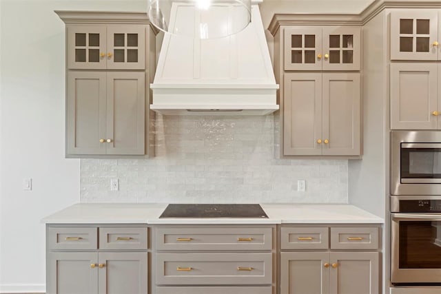 29744 Jade St, Cashion, OK 73016 - kitchen with appliances with stainless steel finishes, custom exhaust hood, and glass insert cabinets