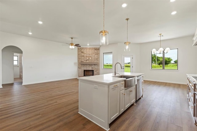 29744 Jade St, Cashion, OK 73016 - kitchen featuring ceiling fan, a fireplace, stainless steel dishwasher, arched walkways, and recessed lighting