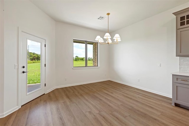 29744 Jade St, Cashion, OK 73016 - unfurnished dining area featuring a chandelier and light wood-type flooring