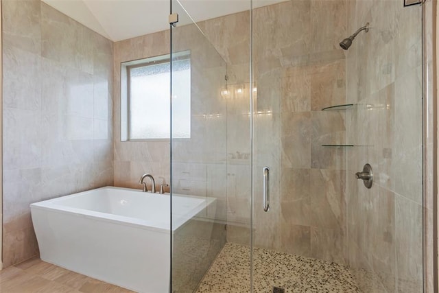 29744 Jade St, Cashion, OK 73016 - full bath with a soaking tub, a stall shower, tile walls, and lofted ceiling