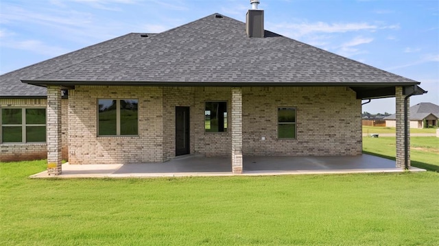 29744 Jade St, Cashion, OK 73016 - rear view of property featuring a shingled roof, a patio, a lawn, a chimney, and brick siding