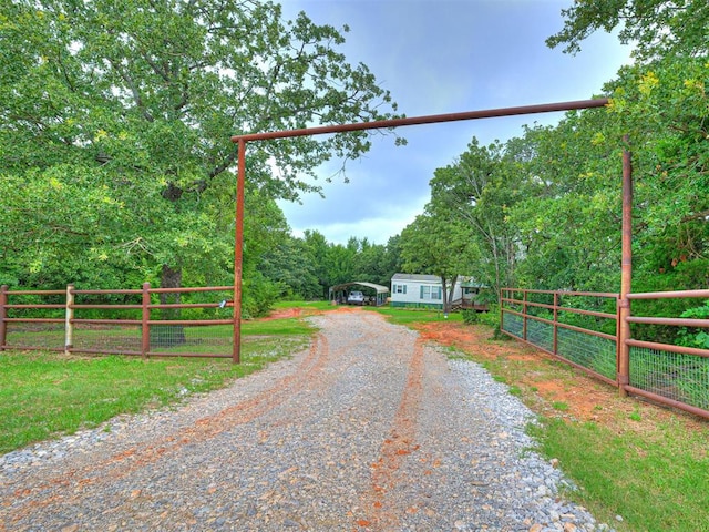 15251 E Waterloo Rd, Arcadia, OK 73007 - view of dirt / gravel driveway with a forest view