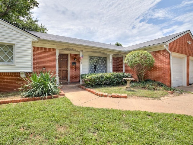 2400 NW 111th St, Oklahoma City, OK 73120 - view of front of home featuring brick siding, an attached garage, driveway, and a front yard